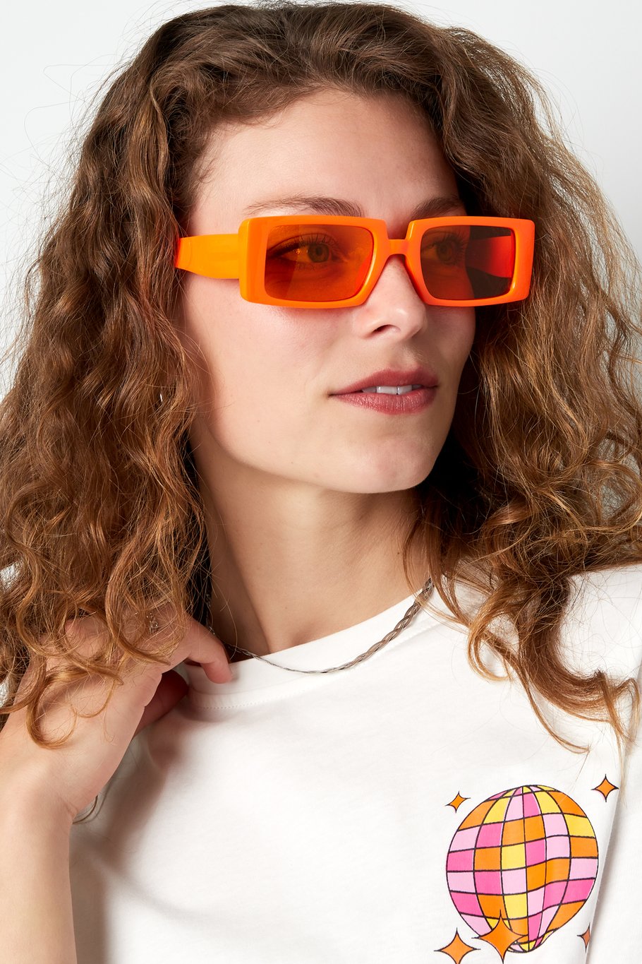 Moderne oranje zonnebril met rechthoekig frame, een opvallend en stijlvol accessoire voor de zomer.